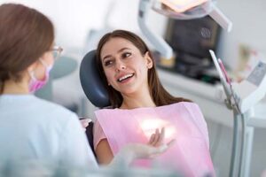 woman smiles while receiving endodontic treatment