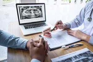 a dentist discusses a patients x rays and care plan