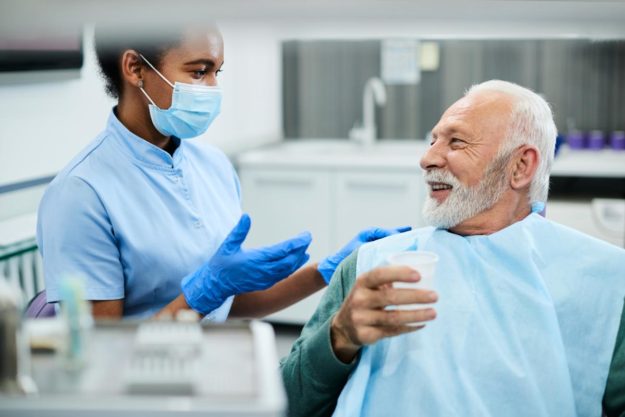a man talking to his dentist about questions to ask before a root canal