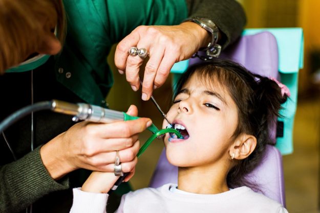 a dentist working on dental injuries in children