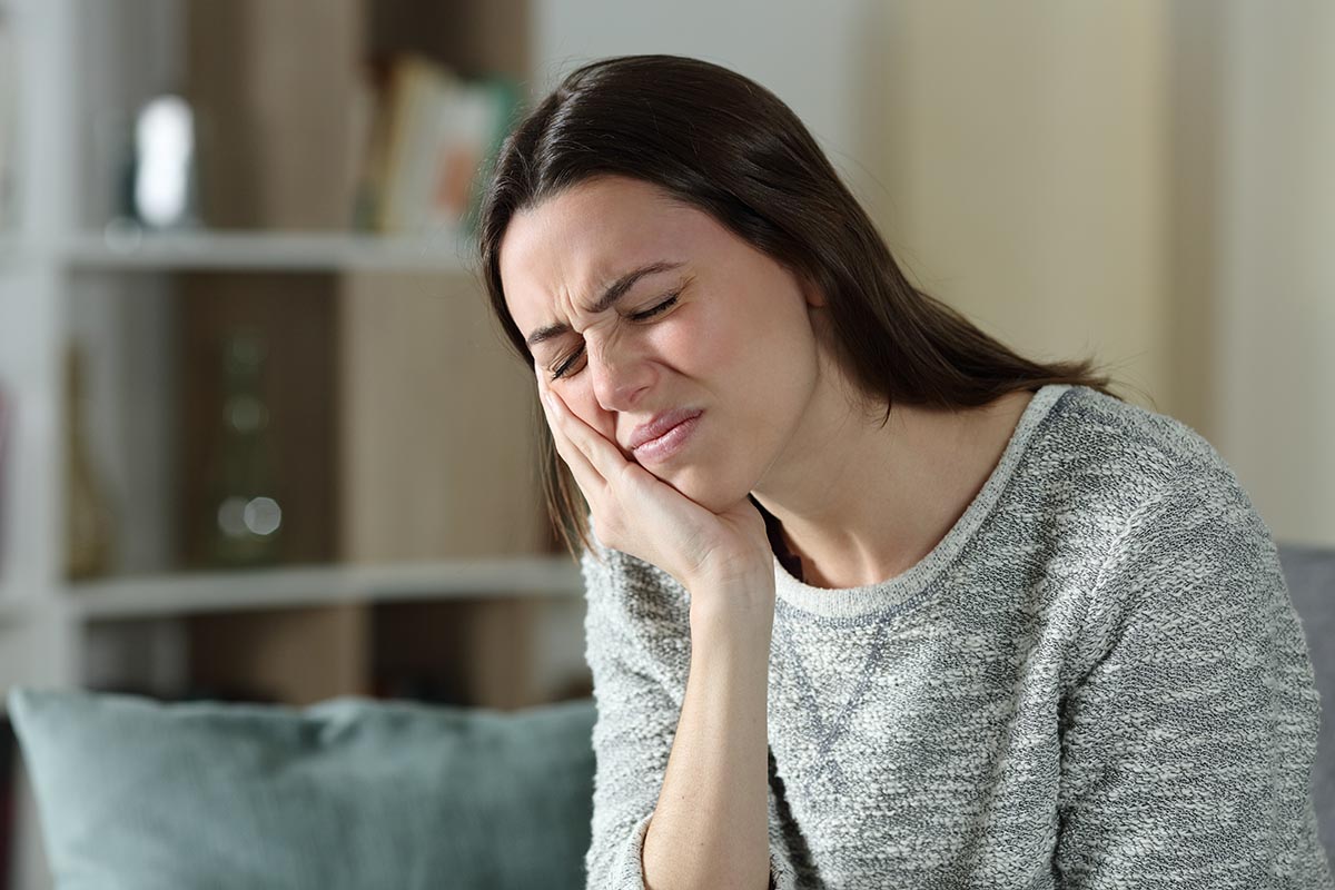 5 Common Causes of Traumatic Dental Injuries woman dealing with common causes of traumatic dental injuries