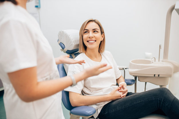 woman in white shirt getting a root canal in Ellicott City, Maryland