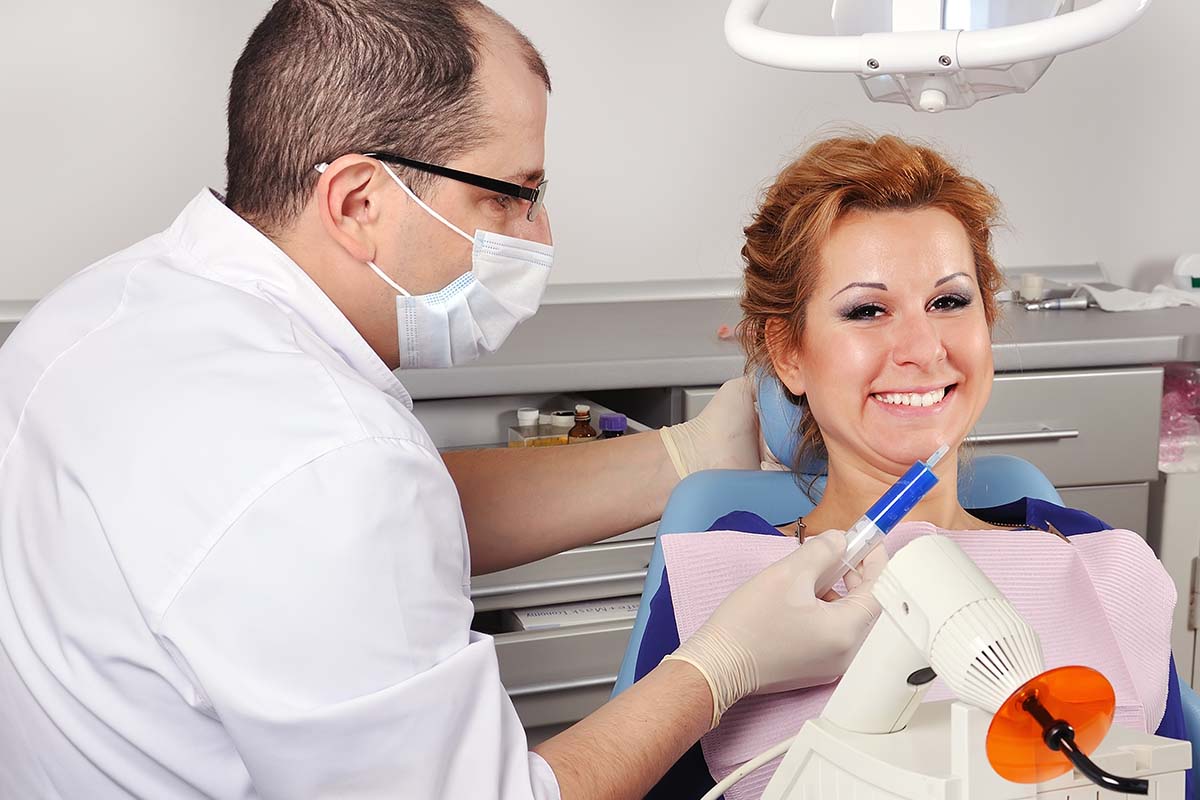 woman smiling and learning different endodontics terms