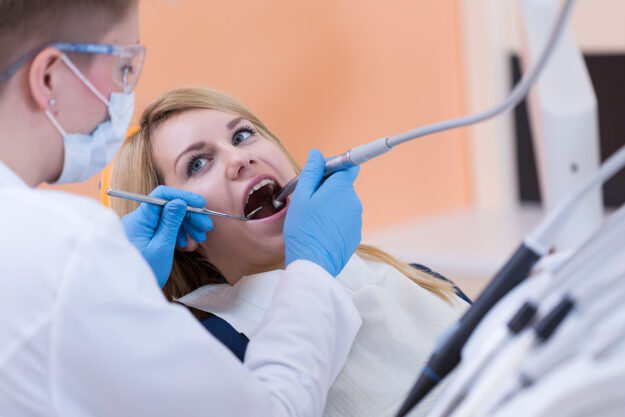 What Are The Benefits of Laser-Assisted Irrigation_ person in dentist's chair learning about the benefits of laser-assisted irrigation