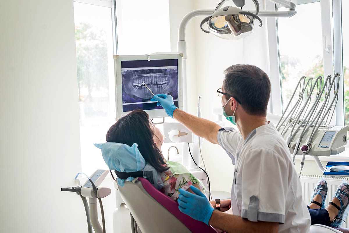 patient talks to endodontist about endodontic retreatment steps