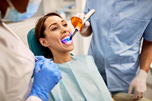 Can laser dentistry be used for root canals woman talks with endodontist about laser dentistry for root canals