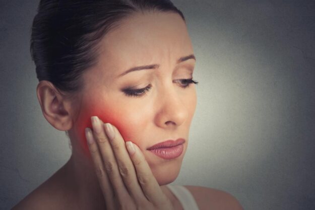What To Do If You’re Still Experiencing Pain After A Root Canal_ woman experiencing pain after a root canal
