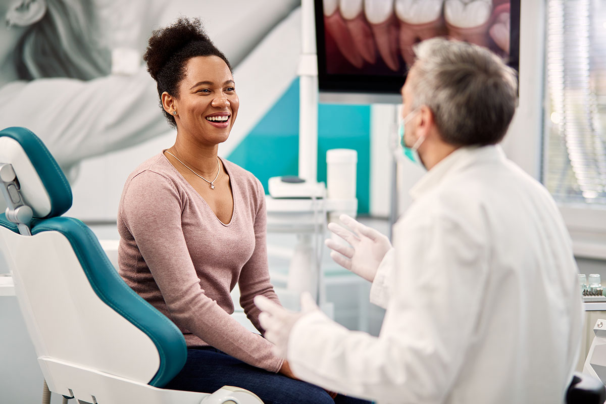 How Is a Root Canal Performed with Laser Dentistry Person asking their dentist, "How is a laser root canal performed?"