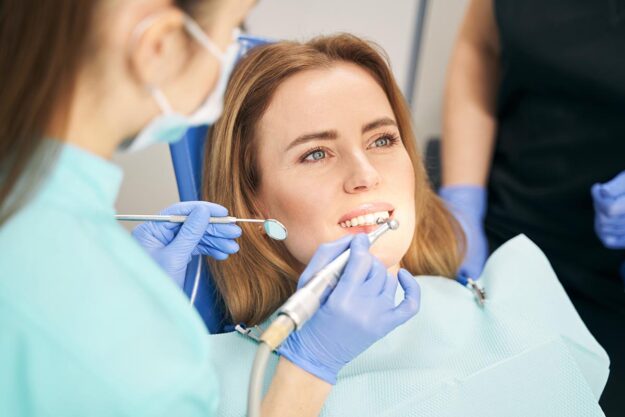 endodontic treatment services Person in dentist's chair thinking about when to see an endodontist