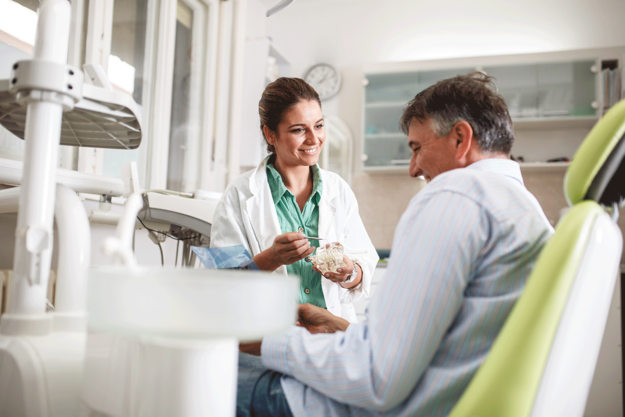 a dentist discusses long term outcomes of apicoectomy with a patient