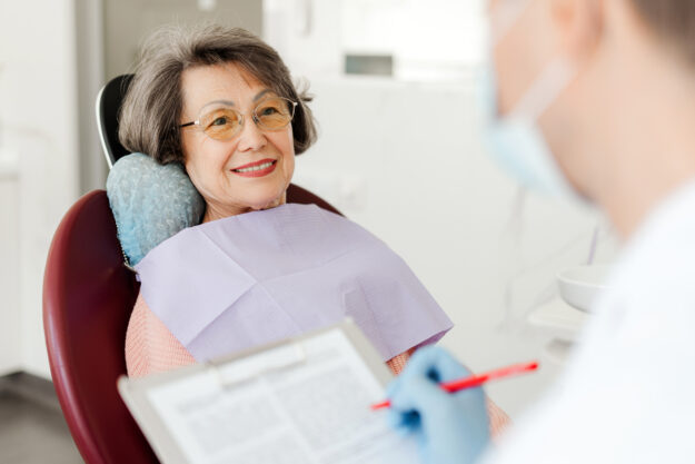 Senior smiling in dentist's chair