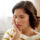 Woman holding her mouth in tooth pain from a cracked crown